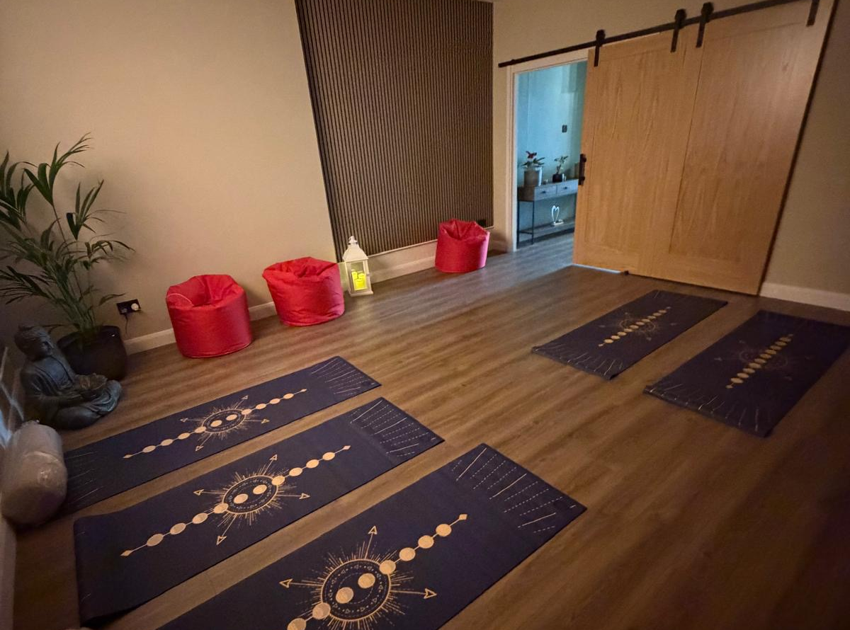 Heal & Thrive wellness space with yoga mats and calming decor