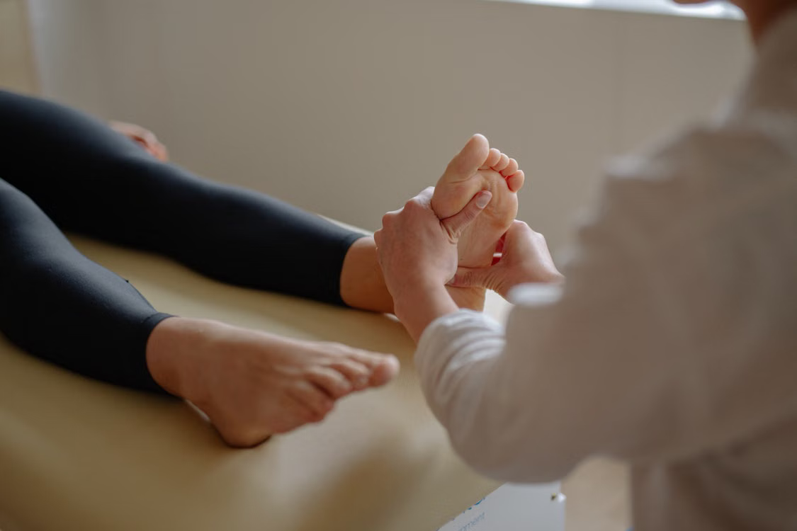 Reflexology treatment - therapist applying pressure to the sole of a foot