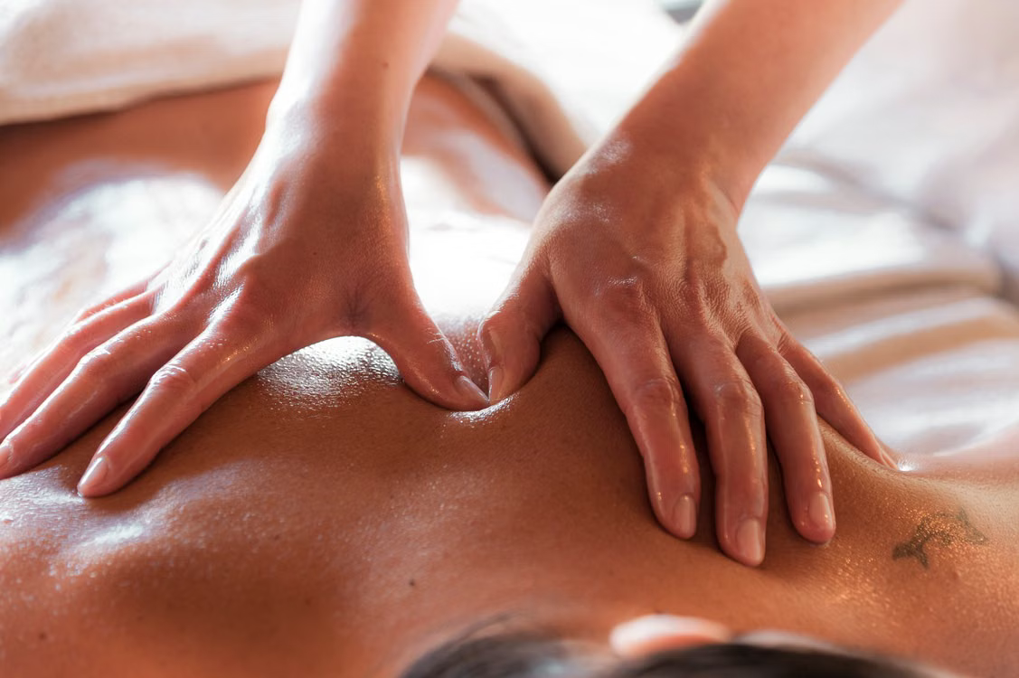 Full body massage treatment - therapist working on client's back